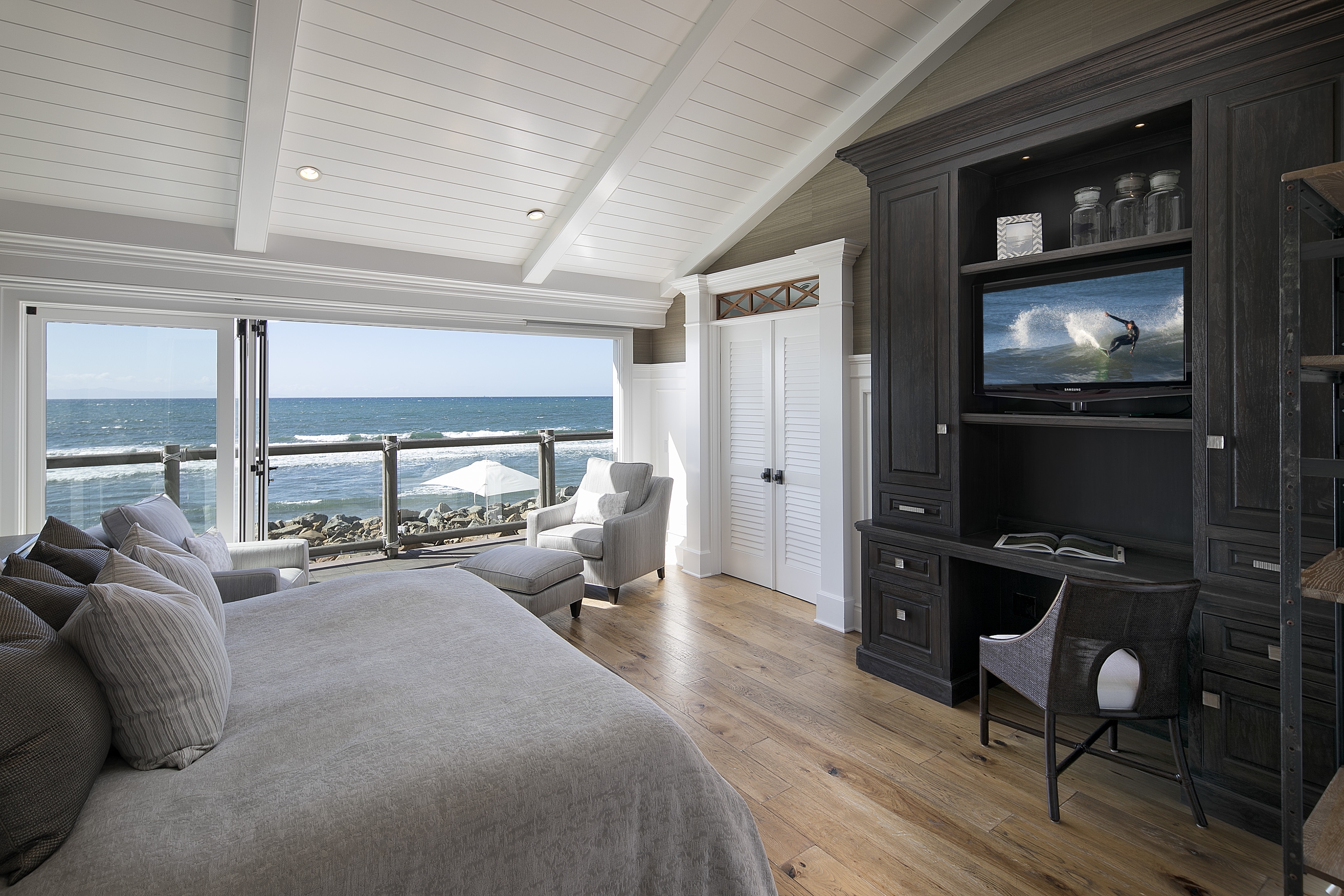 bedroom with windows overlooking ocean